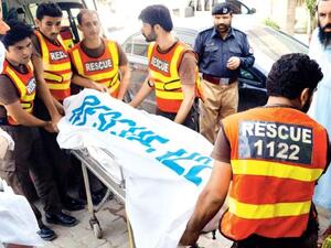 Rescue workers move the body of Ikramullah Gandapur. (AFP/ File)
