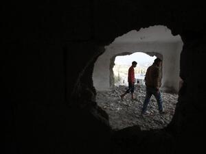 A relative and the brother (R) of late Mohammed Nasser Tarayrah, a Palestinian attacker who stabbed to death an Israeli teen in a Jewish settlement, inspect Tarayrah's home after Israeli army partially destroyed it on August 15, 2016 in the village of Bani Naim, near the Palestinian city of Hebron. (AFP/Hazem Bader)