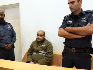 Palestinian Mohammed Halabi (C), the Gaza director of World Vision, a major US-based Christian NGO, looks on during his indictment at a district court in the southern Israeli city of Beersheva on August 4, 2016. (AFP/Dudu Grunshpan)