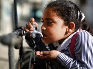 A file photo of a Palestinian child drinking water from a working faucet in Gaza Strip amid a severe water shortage in the besieged territory. (AFP/File)
