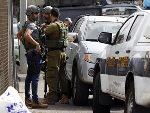 Israeli security forces gather at the site of a reported attack. (Jack GUEZ / AFP)
