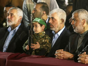 Senior Hamas leaders sit with Fuqaha's son. (AFP/file)