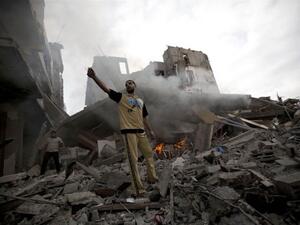 A Palestinian man stands amid debris following an Israeli air strike in Gaza City on July 11, 2014. (AFP/ Mohammed Abed)
