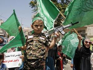 Palestinian Hamas movement supporters march in the city of Hebron in the Israeli-occupied West Bank, on July 28, 2017 (Hazem Bader/AFP)