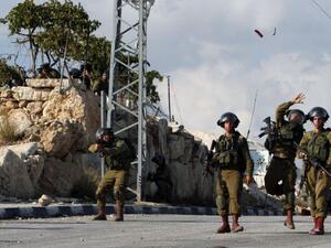Israeli soldiers throw a flash grenade during clashes with Palestinian demonstrators in the West Bank village of Beit Fajjar, on October 31, 2015 (AFP/Musa Al-Shaer)