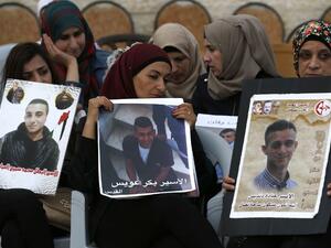 Palestinian women hold portraits of relatives imprisoned in Israeli jails during a protest in front of the Red Cross offices in east Jerusalem on May 25, 2017. The hunger strike was called off on May 27. (Ahmad Gharabli/AFP)