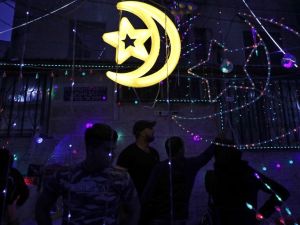 Palestinian men stand amidst Ramadan lights at a shop in the old city of Jerusalem as the faithful prepare for the start of the Muslim holy fasting month of Ramadan on May 26, 2017. (Ahmad Gharabali/AFP)