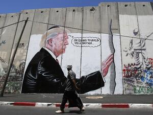 'I'm going to build you a brother' reads new West Bank separation wall graffito (AFP)