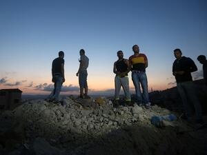 Palestinians stand on the rubble of a house which was demolished by Israeli forces during an overnight raid in the West Bank city of Jenin, Sept. 1, 2015. (AFP/Jaafar Ashtiyeh)