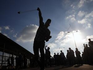 A Palestinian protestor hurls a rock during a demonstration at the Erez crossing with Israel on September 18, 2018, in the northern Gaza Strip. (Said KHATIB / AFP)