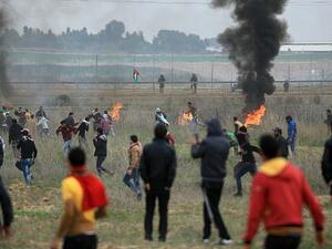 Palestinian protesters clash with Israeli soldiers near the border fence east of Gaza City. (AFP/File)