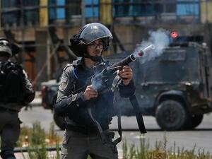 An Israeli border guard fires a teargas canister towards Palestinian protesters during clashes near the settlement of Beit El, near the occupied West Bank city of Ramallah. (AFP/File)