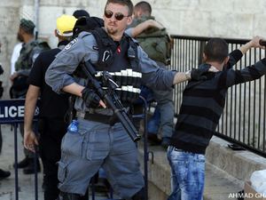 Israeli forces stop and search a Palestinian boy at the entrance of Damascus Gate, outside Jerusalem's Old City. ( AFP / Ahmad Gharabli)
