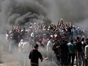 Palestinian demonstrators burn tires near the Gaza-Israel border, east of Gaza City, on May 14, 2018 (AFP/ File Photo, Mahmud Hams)