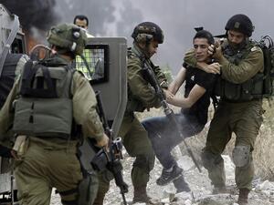 Israeli soldiers detain a Palestinian protester in the West Bank town of Tulkarem. (Jaafar Ashtiyeh/ AFP)
