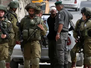 Israeli forces arrest a Palestinian in occupied West Bank. (AFP/ File Photo)