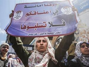 A woman holds a sign reading 'We trust you with our rights, please do not rob them' during a demonstration by UNRWA employees. (Mahmud Hams/AFP) A woman holds a sign reading 'We trust you with our rights, please do not rob them' during a demonstration by UNRWA employees. (Mahmud Hams/AFP)