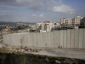 A Palestinian shepherd walks by the controversial wall in East Jerusalem. (AFP/Ahmad Gharabli)