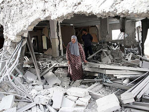 A file photo of a Palestinian woman standing inside her demolished home. (AFP/File)