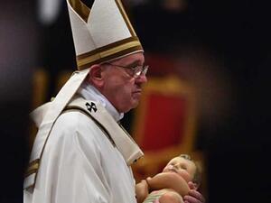 Pope Francis carries the statue of baby Jesus during a mass on Christmas eve marking the birth of Jesus Christ on December 24, 2015 at St Peter's basilica in Vatican. (AFP)