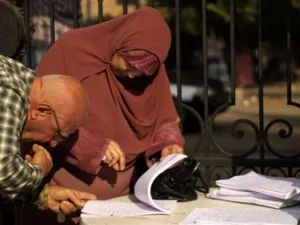 EGYPT, Cairo : An Egyptian man checks for the name of his wife at the entrance of a polling station in Cairo on November 28, 2010, as polls opened across Egypt for a parliamentary election expected to strengthen the ruling party's grip in the most populous Arab nation but marred by a crackdown on the Islamist opposition.