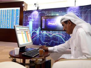 A Qatari trader prepares before the opening of the stock market at the Qatari stock exchange in Doha. (AFP) 