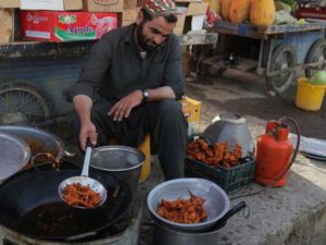 An Afghan vendor prepares traditional food in a street during the month of Ramadan in Ghazni on July 18, 2013.  ( RAHMATULLAH ALIZADA/AFP/Getty Images)