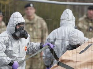 Military personnel wearing protective coveralls work to remove a vehicle connected to the nerve agent attack in Salisbury from a residential street in Gillingham, southeast England, on March 14, 2018. (AFP/ File Photo)