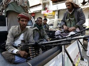 Houthi rebels in front of the residence of former president Ali Abdullah Saleh in Sanaa. (AFP/ Saleh AL Obeidi) 