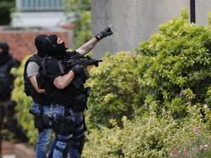 French policemen search house-by-house in Saint-Etienne-du-Rouvray after attackers killed a priest at a church in the village. (AFP/Charly Triballeau)