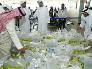 Saudis examine water samples from the Zamzam Well to check for contamination. (AFP/File)