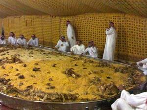 Saudi men and a very large plate of Kabsa. [hotterthanapileofcurry]