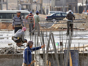 Foreign laborers work at a construction site in the Saudi capital Riyadh. Like women, workers are deprived of the most basic rights in Saudi Arabia.  (Image credit: AFP)