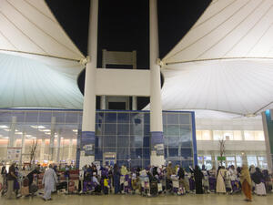 Pilgrims line up outside the Jeddah airport in Saudi Arabia. (Shutterstock)