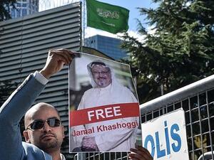 A protester holds a picture of missing journalist Jamal Khashoggi during a demonstration in front of the Saudi Arabian consulate. (AFP/File)