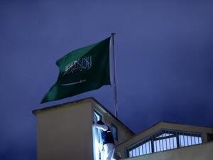 A Turkish forensic stands next to the Saudi flag, on the roof of the Saudi Arabia's consulate in Istanbul on October 15, 2018 during the investigation over missing Saudi journalist Jamal Khashoggi. (BULENT KILIC / AFP)