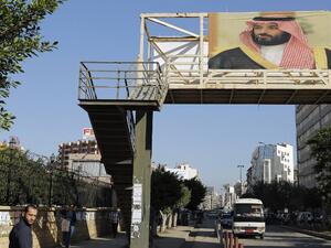 A poster of Saudi Crown Prince Mohammed bin Salman hangs on a pedestrian crossing bridge in the northern Lebanese port city of Tripoli (Joseph Eid/AFP)