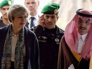British Prime Minister Theresa May (L) is escorted by Saudi Finance Minister Mohammed al-Jadaan, upon their arrival to Saudi Stock Exchange (Tadawul) in the capital Riyadh on April 4, 2017. (AFP)