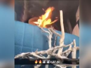 This screengrab from a video shows fire burning inside a container in a car while a Saudi man drives his vehicle. (YouTube/Al-Arabiya)