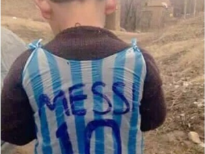 Little is certain about the tiny fan in the plastic jersey, but blogs and social media say he's from war-torn Iraq. (Twitter) 