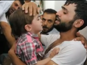 Screenshot of a young Syrian boy being reunited with his father, who believed he was dead. (YouTube)