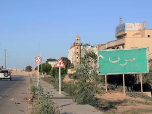 A sign welcomes travelers to Sirte, Libya. (AFP/Mahmud Turkia)