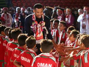 Omani goalkeeper Faiz al-Rushaidi walks among children during a celebration ceremony to welcome Oman's national football team after they won the 23th Gulf Cup of Nations, in Muscat on January 6, 2018.
MOHAMMED MAHJOUB / AFP