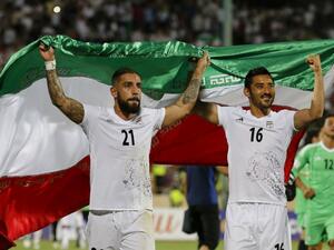 Iran's Ashkan Dejagah (L) Reza Ghoochannejad (R) celebrates among players after winning the 2018 World Cup qualifying football match between Iran and Uzbekistan at the Azadi Stadium in Tehran on June 12, 2017. Iran won 2-0.
ATTA KENARE / AFP