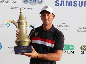 Jamie Elson with the trophy after winning the Ayla Golf Championship on Saturday. (AN photo)