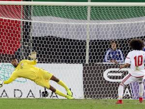 Oman's goalkeeper Fayez al-Rusheidi (L) stops the ball after a penalty by the UAE's player Omar Abdulrahman during the Gulf Cup of Nations 2017 final football match between Oman and the UAE at the Sheikh Jaber al-Ahmad Stadium in Kuwait City on January 5, 2018.
YASSER AL-ZAYYAT / AFP