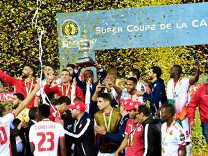 Wydad Casablanca's players celebrate with the champions' trophy after winning the 2018 Total CAF Super Cup match against TP Mazembe, at the Mohammed V Stadium in Casablanca on February 24, 2018.
STRINGER / AFP