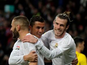 Real Madrid's Welsh forward Gareth Bale (R), Real Madrid's French forward Karim Benzema (L) and Real Madrid's Portuguese forward Cristiano Ronaldo (C) celebrate scoring during the Spanish league football match Real Madrid CF vs Sevilla FC at the Santiago Bernabeu stadium in Madrid on March 20, 2016.
PEDRO ARMESTRE / AFP