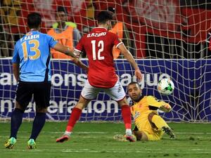Wydad's goalkeeper Zouheir Laaroubi (R) vies for the ball with Ahly's forward Walid Azaro (C) during the CAF Champions League final football match between Al-Ahly vs Wydad Casablanca at the Borg El Arab Stadium in Alexandria on October 28, 2017.
STRINGER / AFP