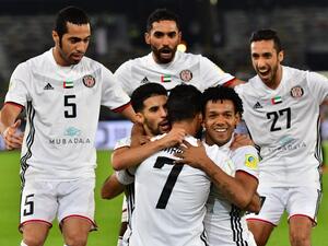 Al-Jazira's Emirati forward Ali Mabkhout (C, front) embraces his teammates Moroccan Mbark Boussoufa (C-L, behind) and Brazillian Romarinho (C-R, behind), as they celebrate after him scoring a goal against Urawa Reds during their FIFA Club World Cup quarter-final match at Zayed Sports City Stadium in the Emirati capital Abu Dhabi on December 9, 2017.
GIUSEPPE CACACE / AFP